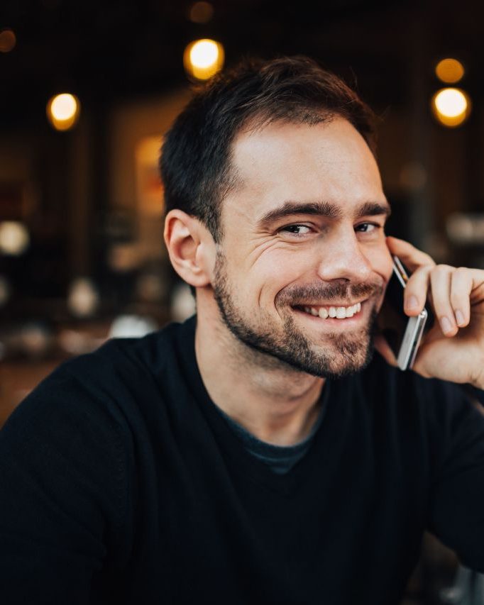 Entrepreneur speaking on the phone while running his digital services business