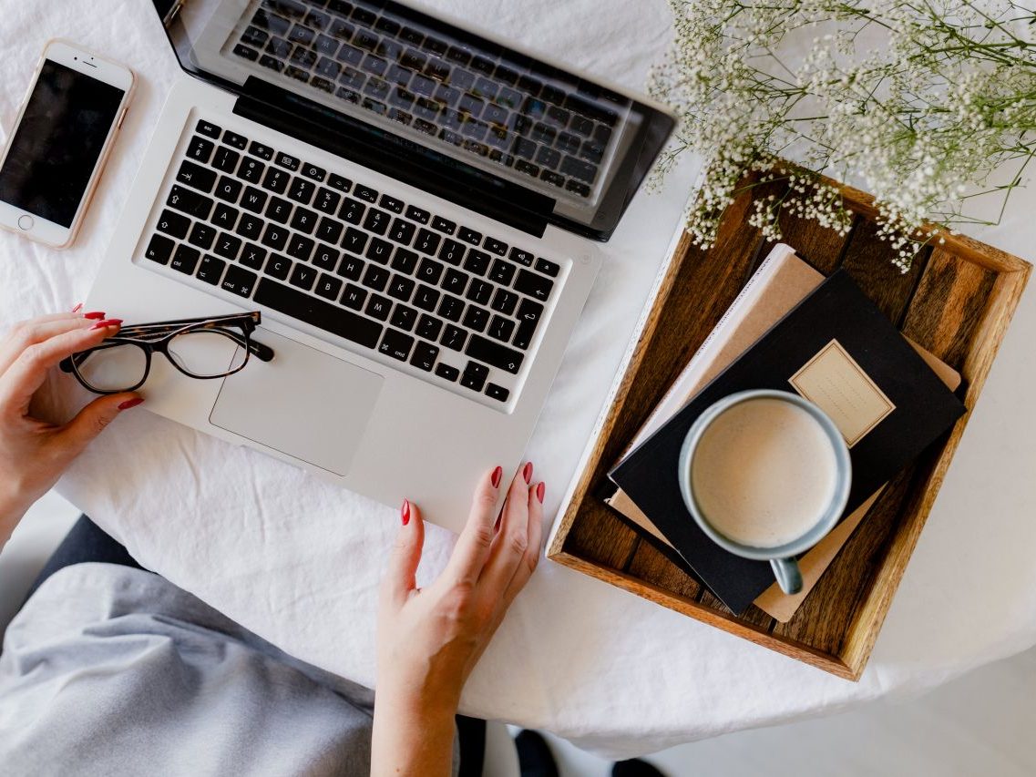 Working from a laptop with a cup of coffee